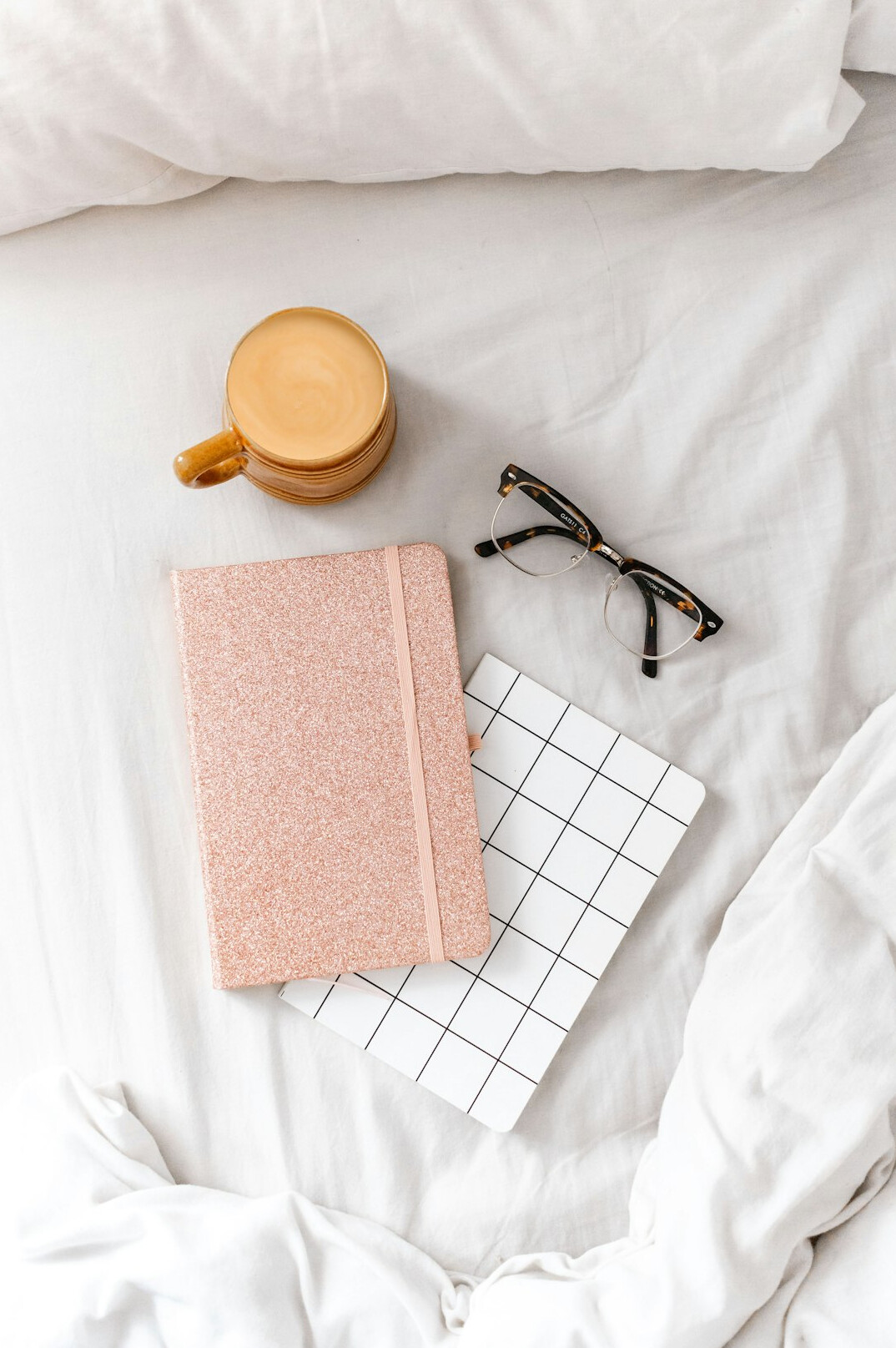 Open notebook with a pen on a wooden desk