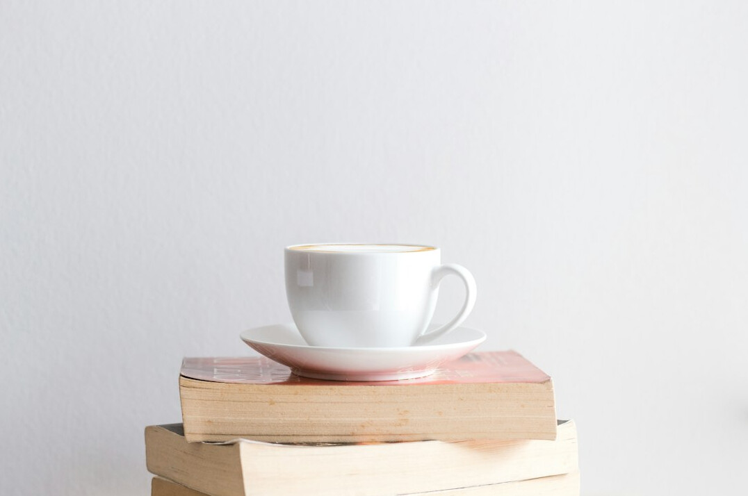 Stack of books with a cup of coffee