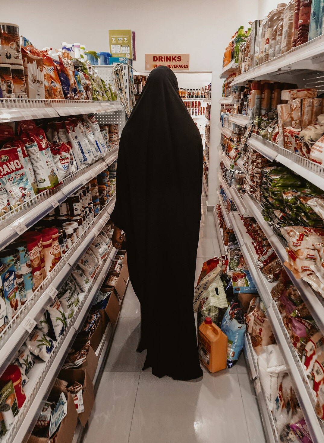 man with backpack in supermarket